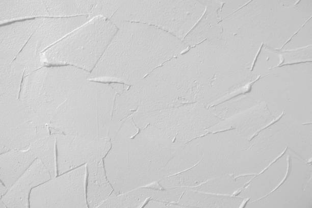 istock White textured wall. Decorative plastering close-up photo. Surface with stucco daub 1128294908