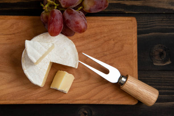istock Cheese and grapes on a dark background 1128295727