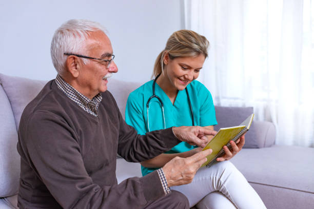 istock Happy patient is holding caregiver for a hand while spending time together. 1128297512