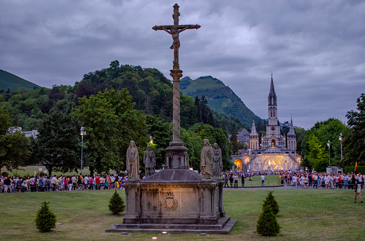 Lourdes, France; August 2013:   Pilgrims partaking in La Procession Mariale Aux Flambeaux or the Torchlight Marian Procession in Lourdes. The torchlight procession takes place at the Domain daily at 9.00pm.
