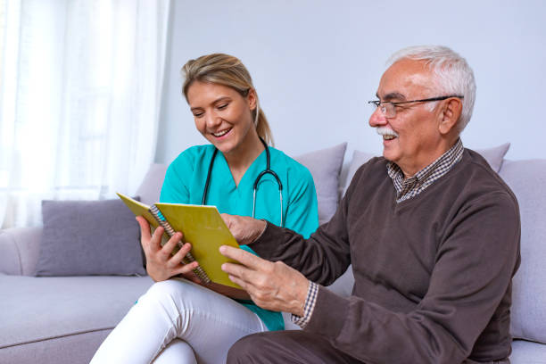 istock Elderly man in nursing home and nurse 1128307477