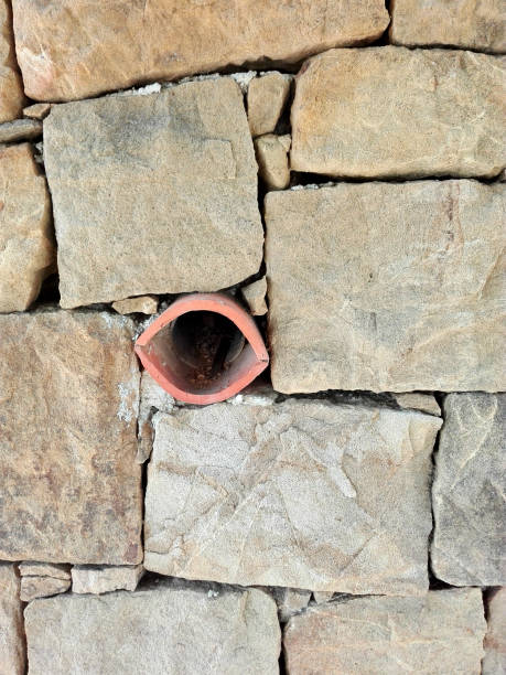 Wall made of beige stones Wall formed by stone blocks with clay drainage capas superpuestas stock pictures, royalty-free photos & images