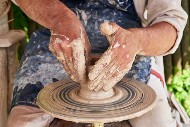 istock Potter forms a vase of clay on a potter's wheel 1128312938