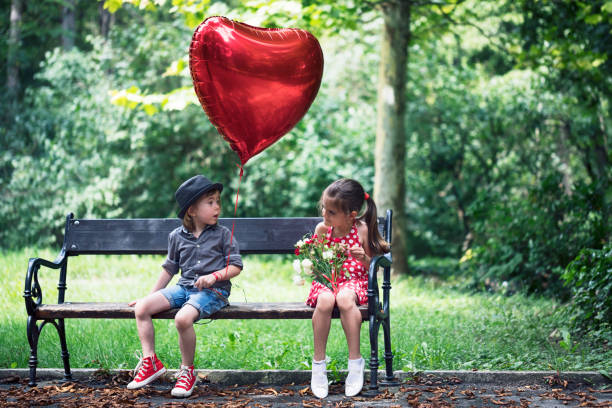 Two children with heart shape balloon stock photo