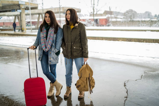 istock Two friends talking and waiting train in railway station 1128316148