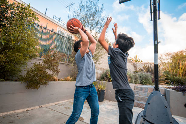 istock Father and son with arms raised playing basketball 1128316822