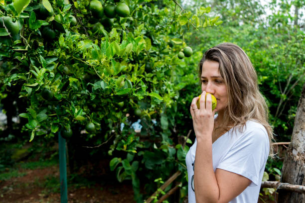 istock young woman smelling freshly picked lime 1128317126