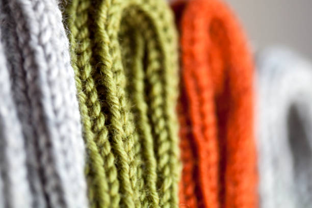 Orange, green and grey wool knitted texture stock photo