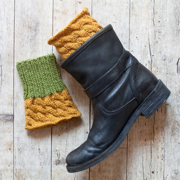 istock black leather boot and knitted wood legwarmers 1128318294