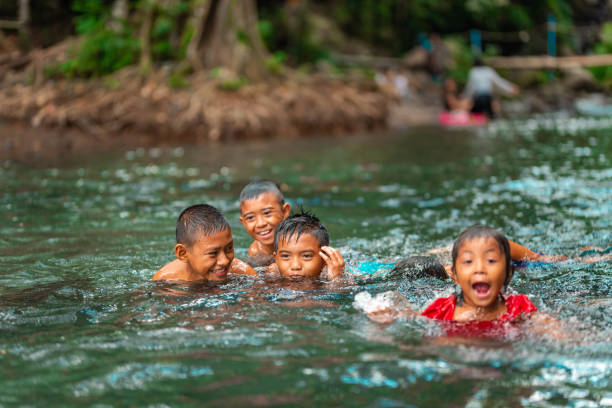 istock Indonesian children playing in the river 1128319314