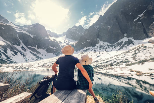 Active family leisure, spring summer hiking. Father and son rest near the mountain lake Active family leisure, spring summer hiking. Father and son rest near the mountain lake pleso stock pictures, royalty-free photos & images