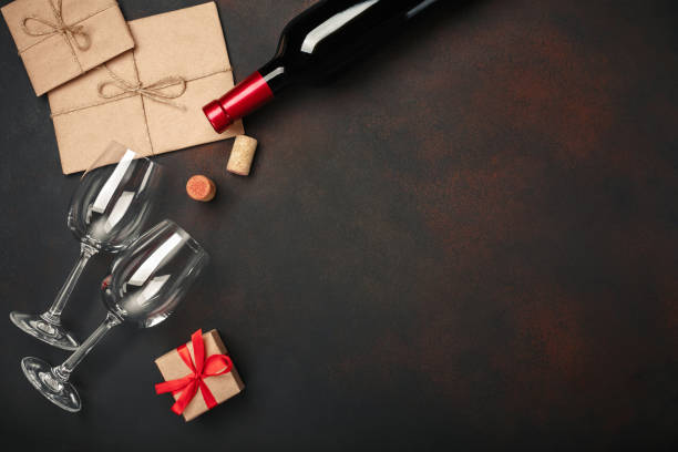 istock Heart shaped pizza with mozzarella, sausagered, wine bottle, two wineglass, gift box on rusty background 1128324100