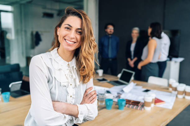 istock Business woman with his team behind 1128324339
