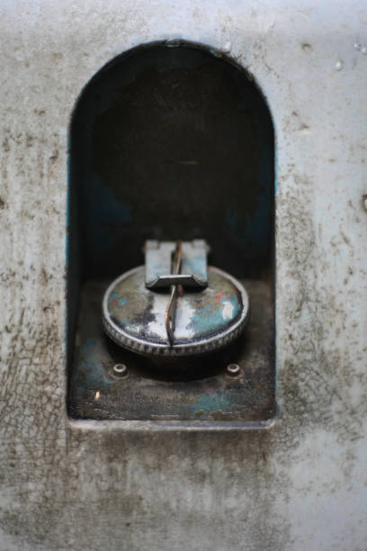istock Old hand painted car filler cap, rusty and flaking grey paint. Front focus. 1128331462