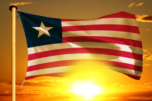 Liberia flag weaving on the beautiful orange sunset background
