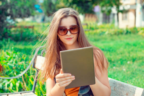 istock woman girl student looking on digital pad tablet 1128335342