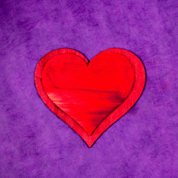 red wooden hearts on coloreful background for Valentine's day or love celebration concept