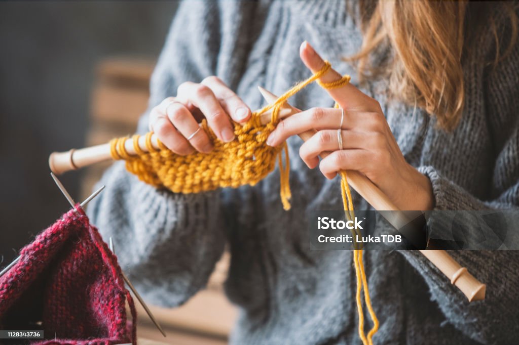 Close up on woman's hands knitting Knitting Stock Photo