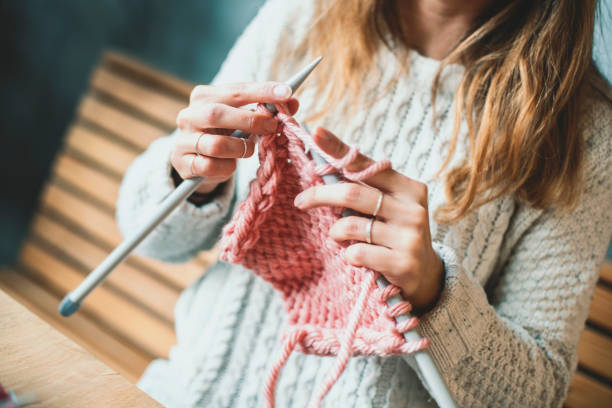 Close up on woman's hands knitting