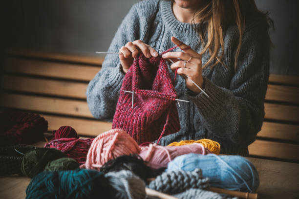istock Close up on woman's hands knitting 1128343738