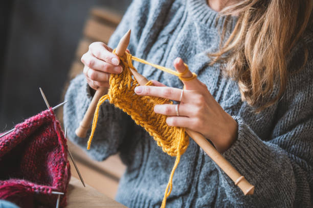 istock Close up on woman's hands knitting 1128343741
