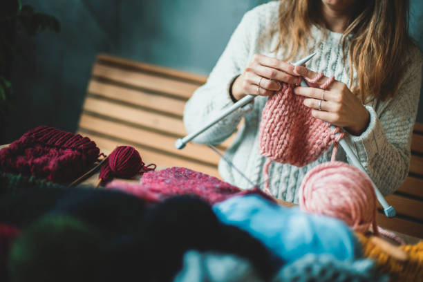 istock Close up on woman's hands knitting 1128343752