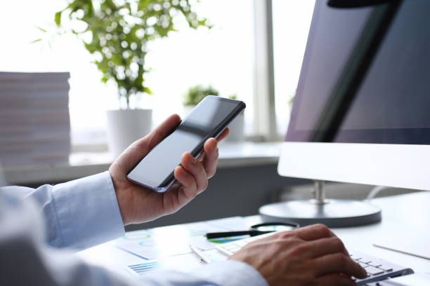 istock Businessman hipster holds telephone background of 1128343834