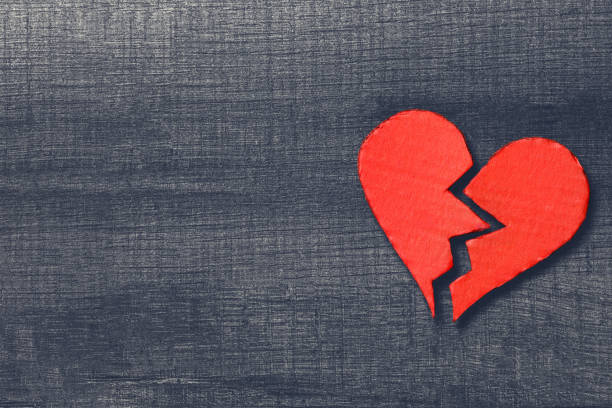 istock Valentine's Day. Broken heart with copy space on wooden table 1128343865