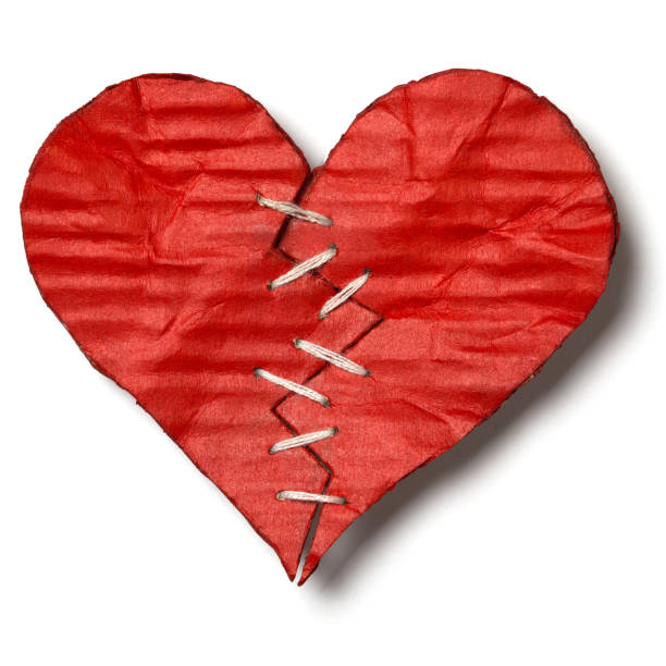 istock Valentine's Day. Broken heart with white stitches isolated on white background. Cut out 1128343919