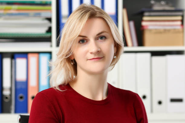 istock Normal blond woman portrait at office 1128343928