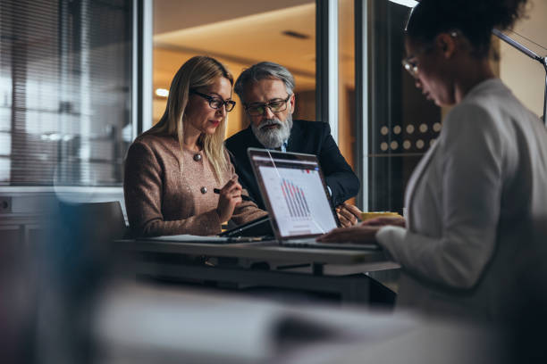 istock Working late with business colleague  in office 1128346109