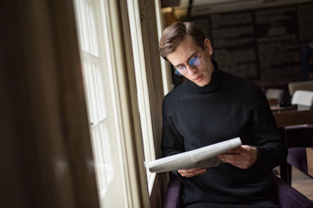istock Young businessman reading a newspaper 1128349023