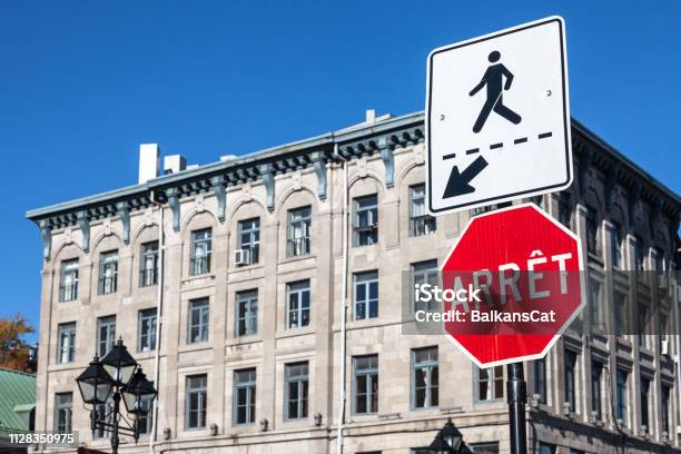 Quebec Stop Sign Obeying By Bilingual Rules Imposing Use Of French Language On Roadsigns Translatingstop Into Arret Taken In Montreal Canada Next To A Sign Indicating A Pedestrian Crossing Stock Photo - Download Image Now