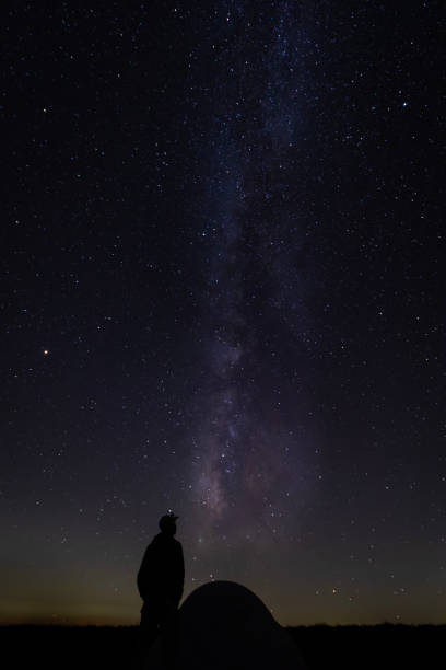 istock Hiker with tent gazing at milky way 1128351222