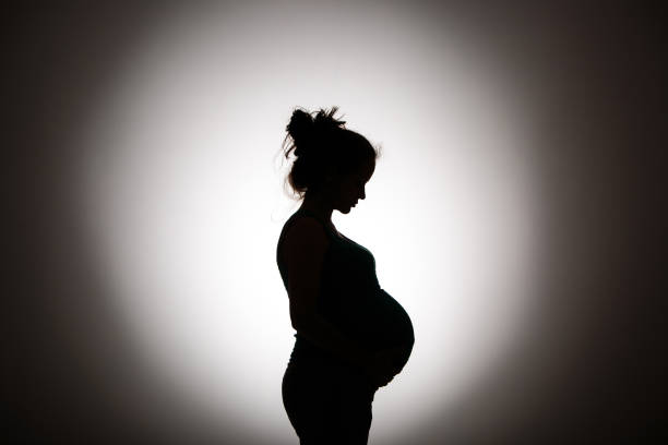 silhouette - one person women human pregnancy beautiful photos et images de collection