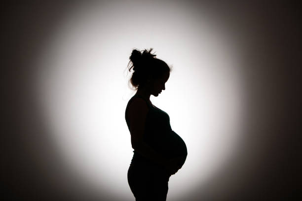 silhouette Silhouette of pregnant woman human abdomen stock pictures, royalty-free photos & images
