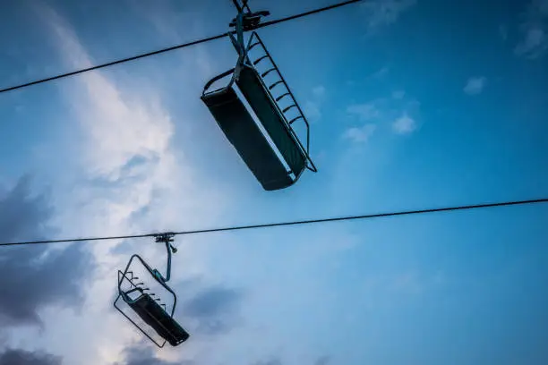 Chair lift at a ski resort in the mountains in the summer at sunset