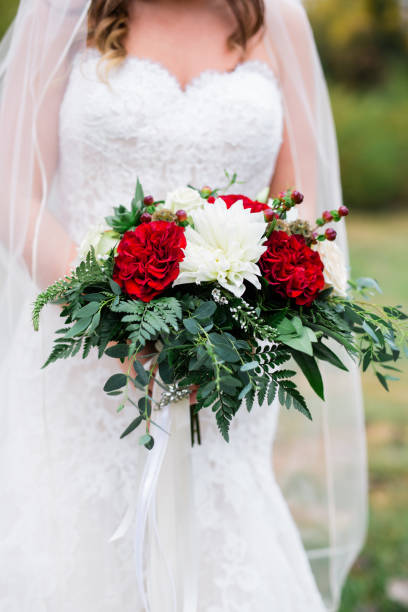 istock Bride in White Wedding Dress Holding Bouquet 1128358316