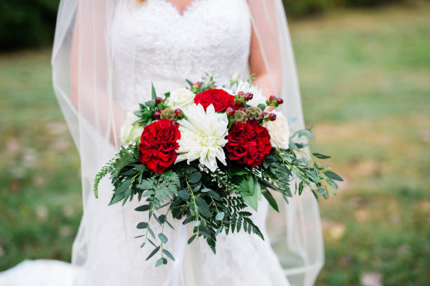 istock Bride in White Wedding Dress Holding Bouquet 1128358318