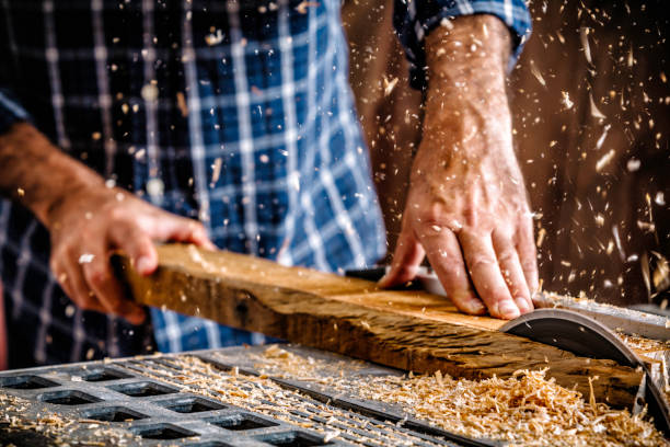 istock Mature Hispanic carpenter using saw in home workshop 1128358332