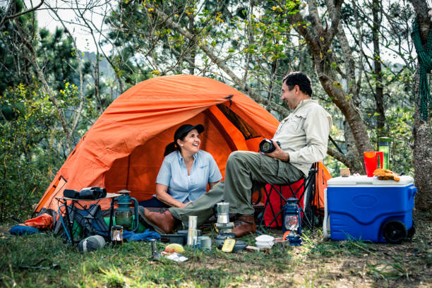istock Relaxing mature Hispanic couple camping in the wilderness 1128359053