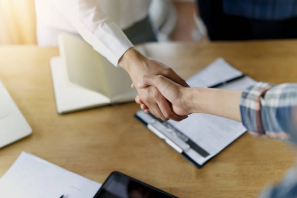istock Hands shaking of two business women. 1128363512