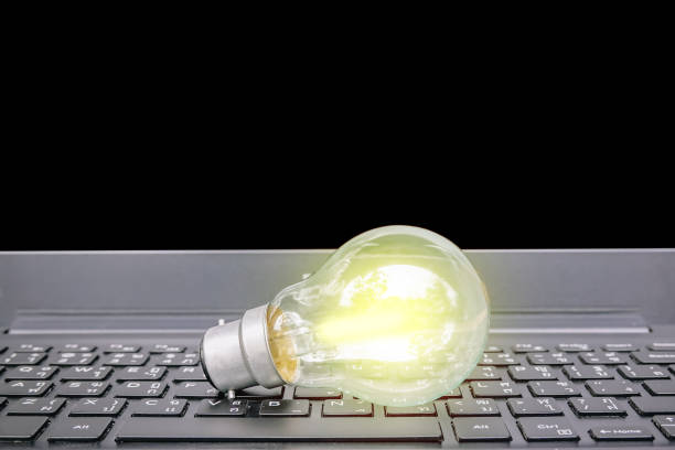istock Closeup light bulb on keyboard laptop, Light bulbs with new ideas, innovation, inspiration and creativity concept. 1128363812