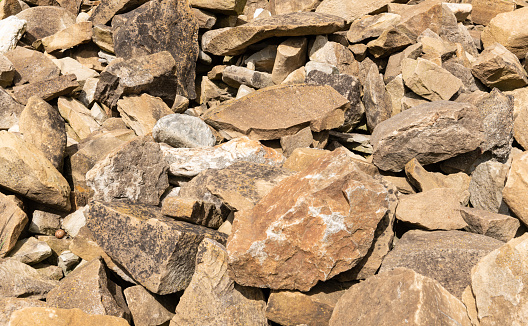 Pile of medieval wall stones or rocks  of irregular sizes.