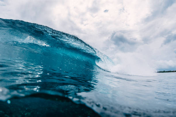 istock Big blue wave in ocean. Breaking wave in Oahu 1128376333