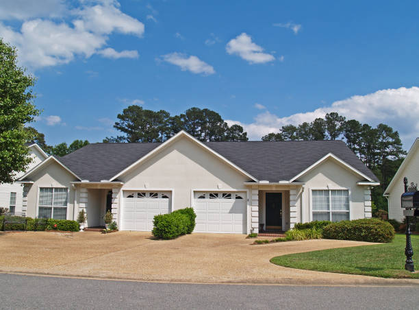 New One Story Small White Vinyl Duplex Homes Thomasville, Georgia, USA – April 27, 2010:  New low income small one story white vinyl duplex unit with garages in the front. duplex stock pictures, royalty-free photos & images