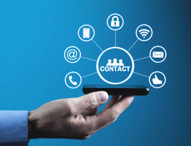 istock Man holding phone with contact icons. 1128383090