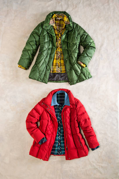 Bomber jackets with plaided shirts isolated on beige background