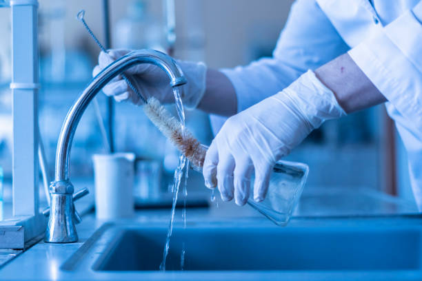 istock scientist wash beaker from poisonous acid after experiments b 1128387163
