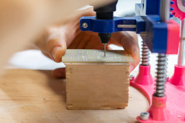 istock young male doing holes in electrinic or silicon plate b 1128387228